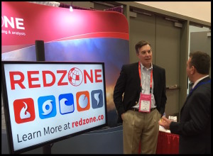 Michael discusses RedZone's capabilities with an attendee.