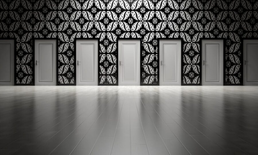 Row of identical doors along a patterned corridor wall