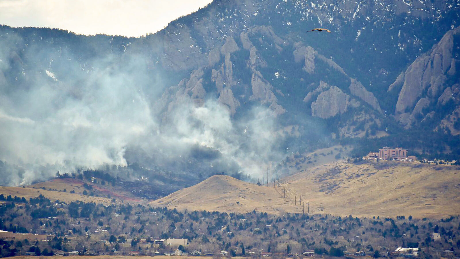 Smoke rising from a burn below the Flatirons outside Boulder, Colorado