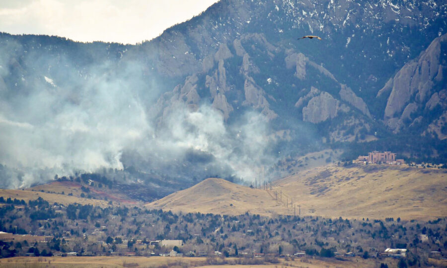 Smoke rising from a burn below the Flatirons outside Boulder, Colorado