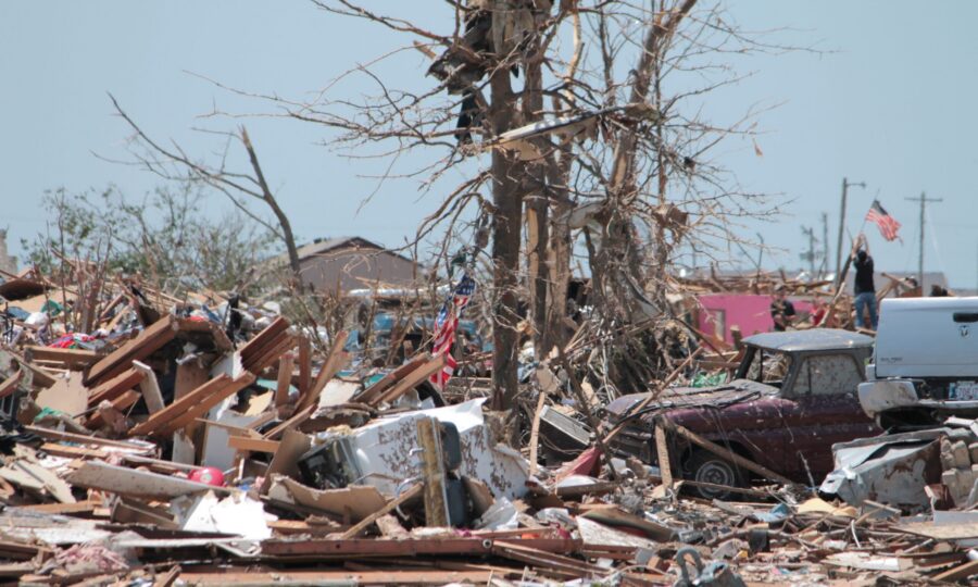 Splintered debris and stripped trees left by a tornado