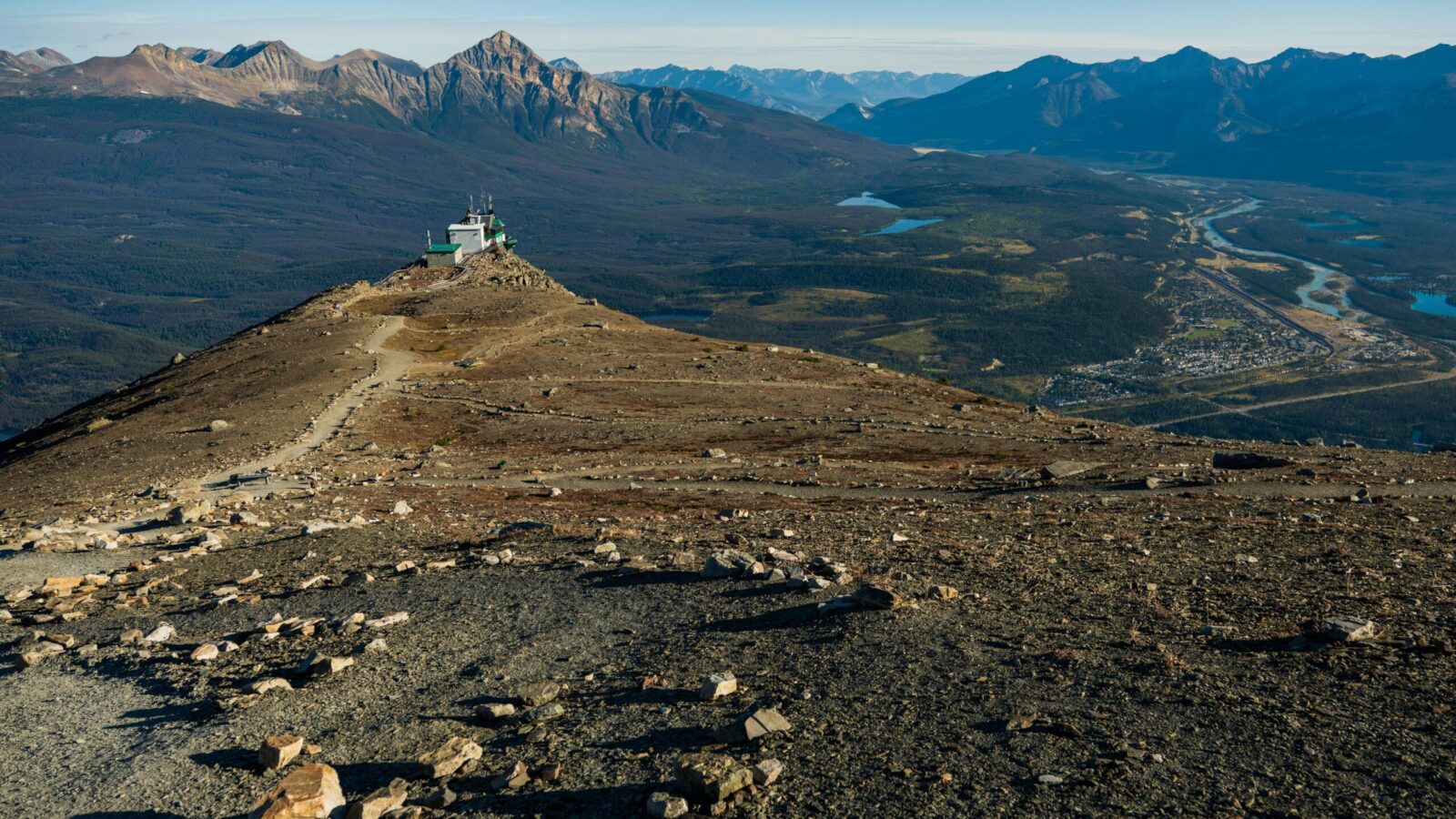 Mountain ridge rising above a valley town in the Canadian Rockies