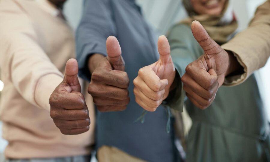 Several people giving a thumbs-up together